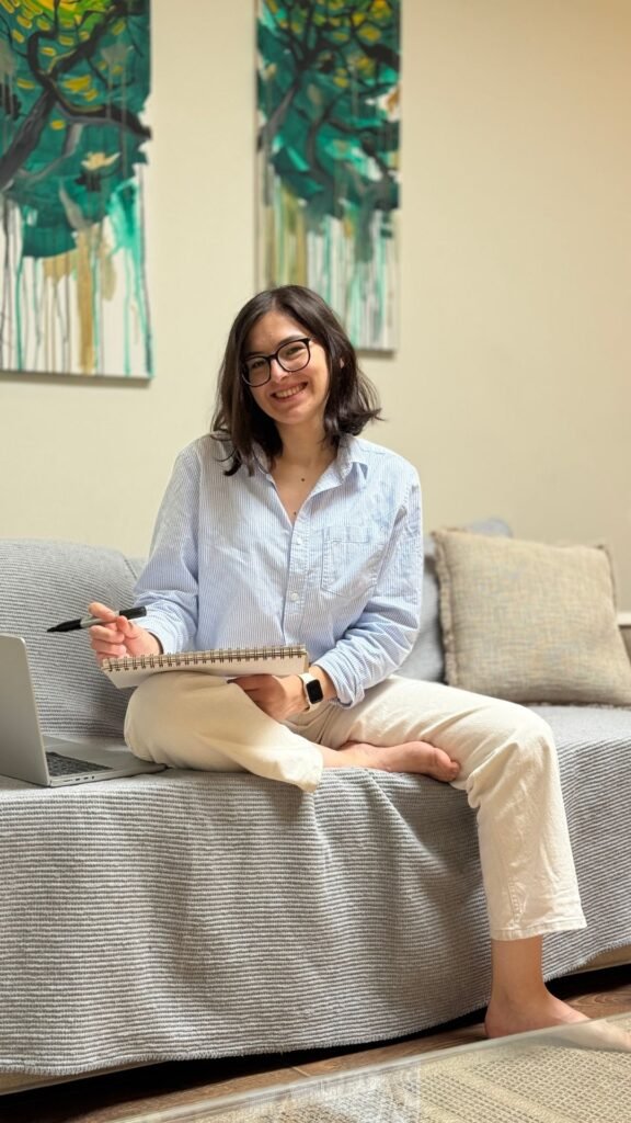 Ana Jomir sitting with a sketchbook